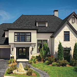 Front view of a generic mid-class home with charcoal black GAF shingles on its roof